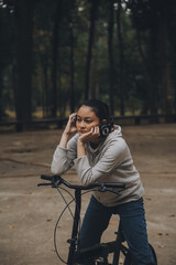 Happy Asian young woman walk and ride bicycle in park, street city her smiling using bike of transportation, ECO friendly, People lifestyle concept.