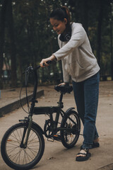 Obraz premium Happy Asian young woman walk and ride bicycle in park, street city her smiling using bike of transportation, ECO friendly, People lifestyle concept.