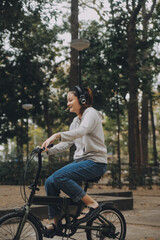 Obraz premium Happy Asian young woman walk and ride bicycle in park, street city her smiling using bike of transportation, ECO friendly, People lifestyle concept.