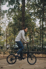 Naklejka premium Happy Asian young woman walk and ride bicycle in park, street city her smiling using bike of transportation, ECO friendly, People lifestyle concept.
