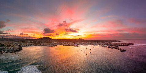Spectacular aerial panoramic landscape image of the evening sunset sky at golden hour over the town of Corralejo, Fuerteventura, Canary Islands, Spain