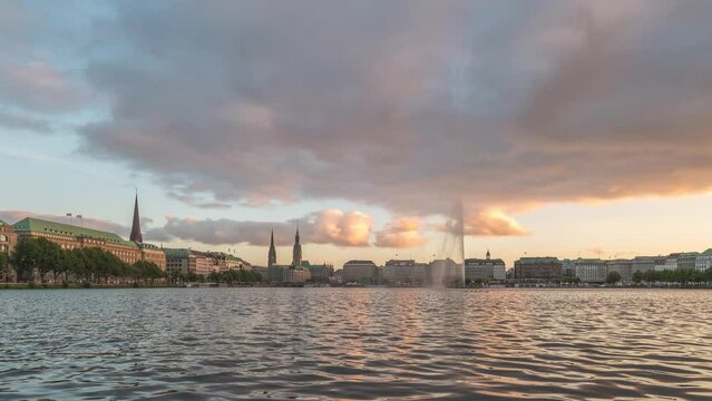 Hamburg Germany time lapse, day to night city skyline at Alster Lake with Fountain