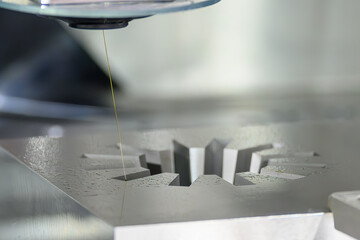 Closeup scene the wire EDM machine cutting the mold parts.