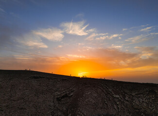 Spectacular sun set image over Volcan Calderon Hondo volcanic crater silhouetted against the setting sun and skyscape near Corralejo, Fuerteventura, Canary Islands, Spain