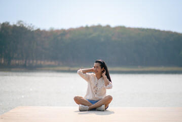 Beautiful girl, sexy woman, relaxing at the lake, relaxing in nature. Holiday tourism.