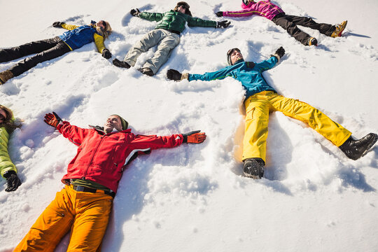 Group of friends doing yoga in snowy mountains in winter. Achenkirch, Austria 