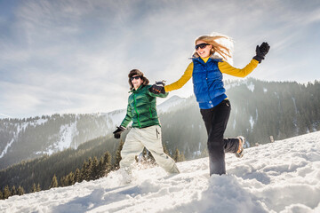 Couple having fun in the mountains in winter. Achenkirch, Austria 