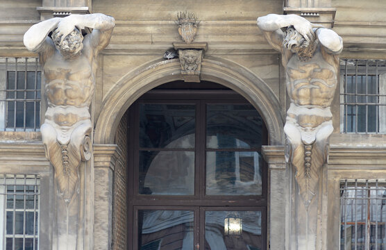 Entrance of the Palazzo Gio Carlo Brignole with tritons and IHS sign in Genoa, Italy