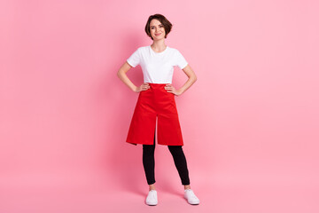Full length body size photo woman confident wearing white t-shirt red apron smiling isolated pastel pink color background