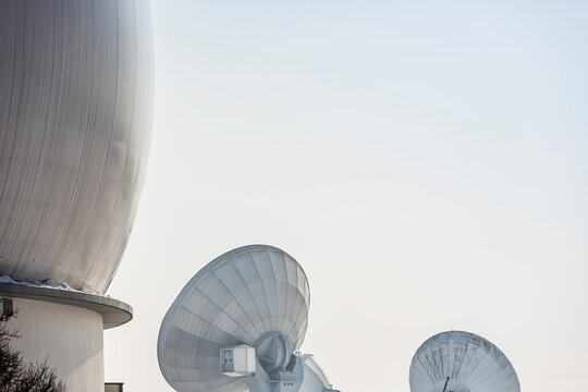 Uplink satellite station in winter landscape with snow and blue skies. 