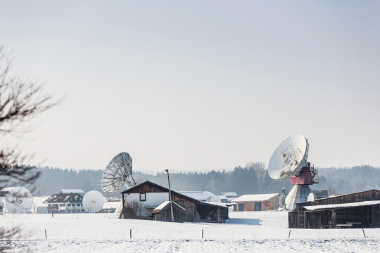 Uplink satellite station in winter landscape with snow and blue skies. 