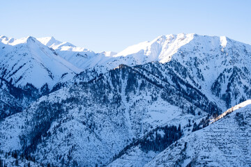Winter landscape in the mountains not far from the city of Almaty. View of Kumbel Peak.
