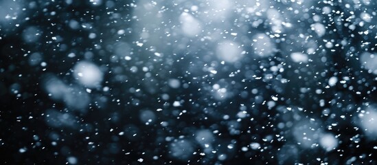 Snowstorm stock image with falling snow on black background.