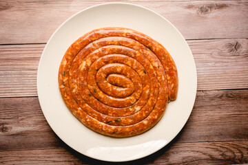long circular chorizo on white plate