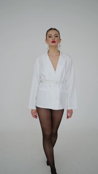 Elegant Woman in Chic White Blazer and Black Tights - Fashion Statement