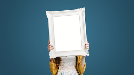 Beautiful woman posing and holding a frame - obrazy, fototapety, plakaty