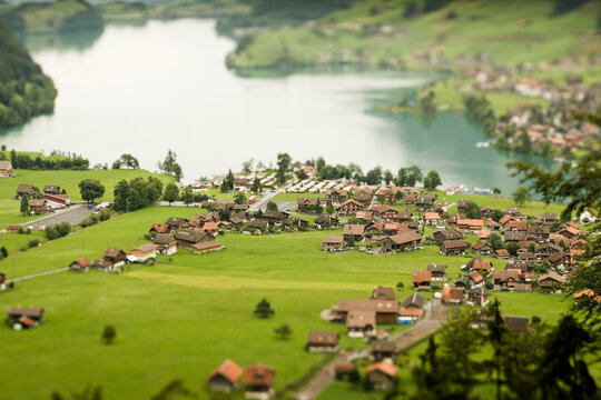 Tilt shift image of village with mountains in the background. Switzerland