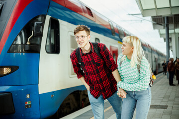 Obraz premium Portrait of a young couple rushing on a metro train in subway.