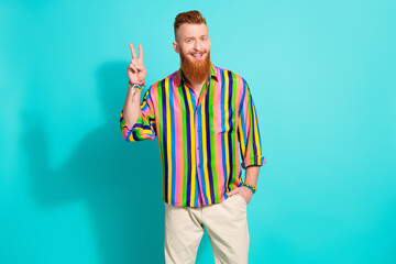 Photo of cheerful nice man wear trendy colorful clothes hello hi v-sign isolated on cyan color background