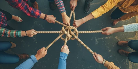 Fototapeten Diverse Team Uses Strong Rope To Form A United Partnership And Communicate Effectively. Сoncept Team Building Exercises, Communication Skills, Trust Building, Unity And Collaboration © Ян Заболотний