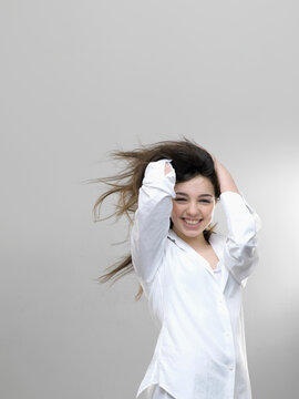 Studio portrait of happy smiling girl with gray background