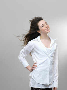 Studio portrait of happy smiling girl with gray background