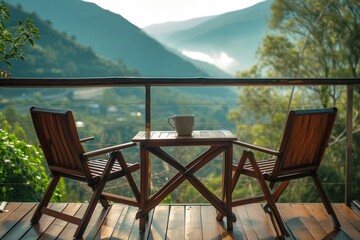 Nature view with two chairs on a wooden table. Have a cup of coffee on the balcony with a view of nature and mountains.
