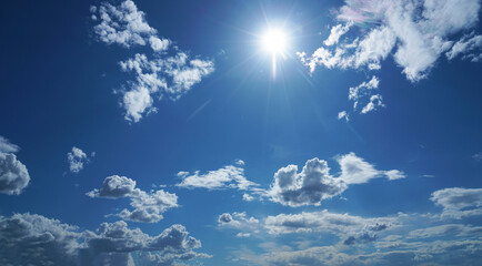 Rays of the sun from behind the clouds in the blue sky. blue sky with cloudy heaven and sunrays....