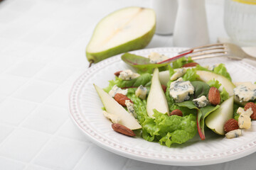 Delicious pear salad on white tiled table, closeup. Space for text