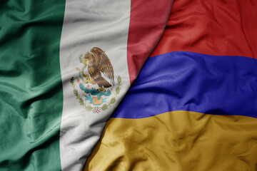 big waving national colorful flag of armenia and national flag of mexico .