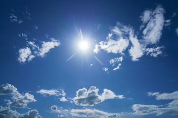 Rays of the sun from behind the clouds in the blue sky. blue sky with cloudy heaven and sunrays....