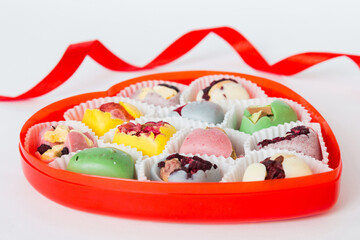 Valentine day composition: sweet candy, with gift boxes with bow and red felt hearts, photo template, background. Perspective View with copy space