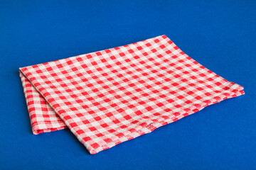 top view with red empty kitchen napkin isolated on table background. Folded cloth for mockup with...