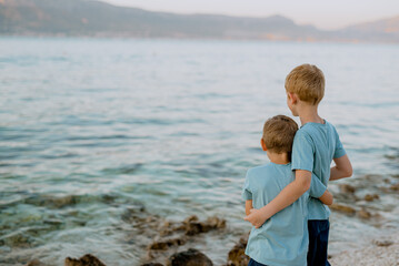 Two boy brothers on the beach in summer