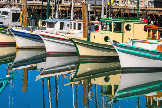 Fisherman boats reflected in the water in San Francisco, USA.