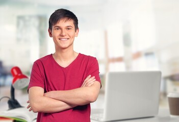Ambitious handsome male employee posing in office