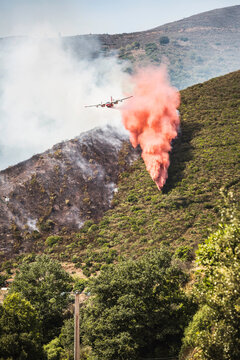 Plane dropping flame retardant, ammonia sulfate, onto wild fire in the mountains of Corsica.