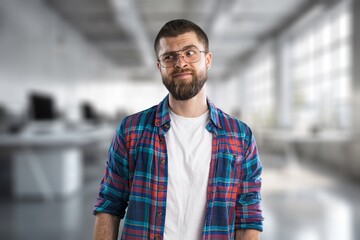 Ambitious handsome male employee posing in office