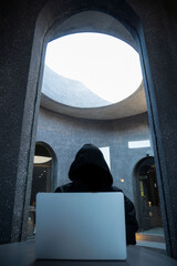 Male hacker in dark room using laptop internet hacking