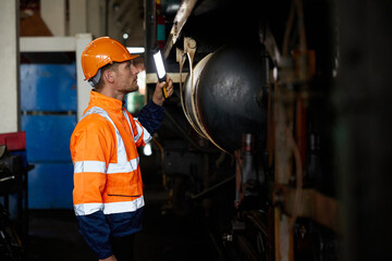 engineer or technician using light stick and checking construction train at station