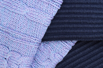 Knitted wool sweaters. Pile of knitted winter clothes , sweaters, knitwear, space for text.