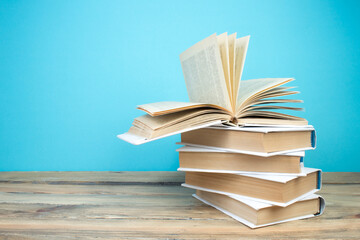 open book, books on the blue background. Back to school. Education. Copy space for text.