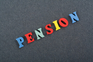 PENSION word on black board background composed from colorful abc alphabet block wooden letters, copy space for ad text. Learning english concept.