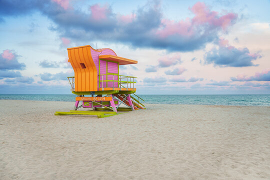  Vibrant, pastel view of lifeguard tower colorful painted under bright blue sky on South Beach, Miami, Florida.
