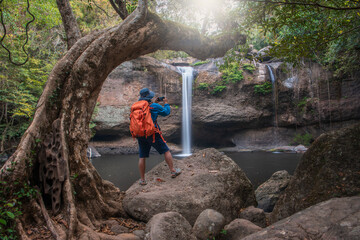 Tourists stand and take photos of the beautiful scenery of Haew Suwat Waterfall. Khao Yai National...