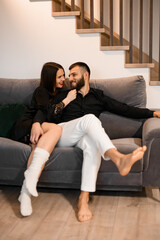 Valentine's couch bliss. Couple cherishes each other on the sofa, sharing love on Valentine's Day.
