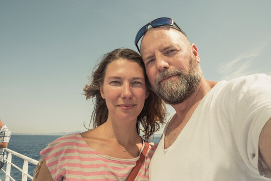 Portrait of man and woman on a ferry in summer. Elba, Italy