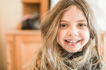 Cute young girl looks happily into the camera. Munich, Germany