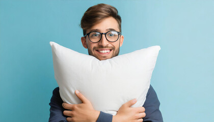 World Sleep Day with young man holding soft pillow against light blue background.Copy space.