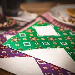 Obraz premium Mock up Label the blank menu frame in Bar restaurant ,Stand for booklets with white sheets paper acrylic tent card on wooden table cafeteria blurred background can inserting the text of the customer.